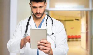 Doctor holding tablet focused
