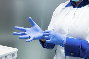Doctor putting gloves on