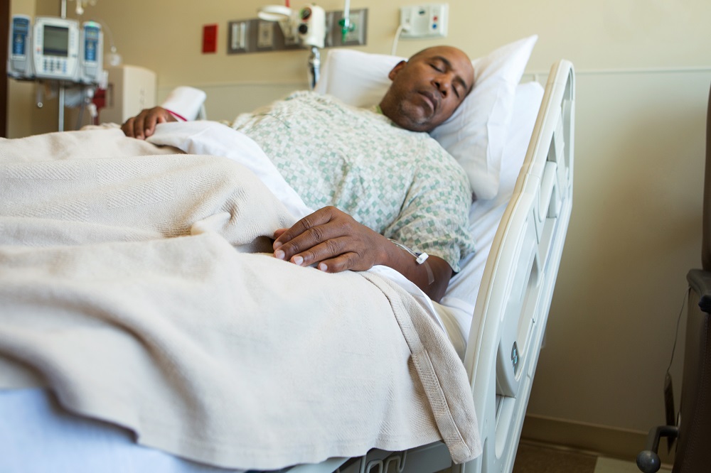 african american man in hospital bed due to medical malpractice or negligence