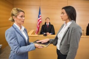 how na expert witness can help your case - brunette woman is sworn in in a courtroom