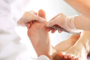 podiatrists work on patient's foot